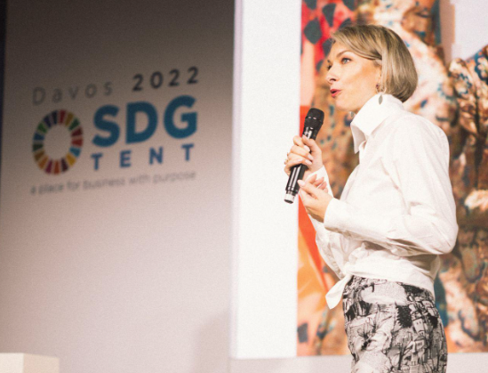 Nicky Myny speaking on stage at the SDG Tent, Davos 2022.