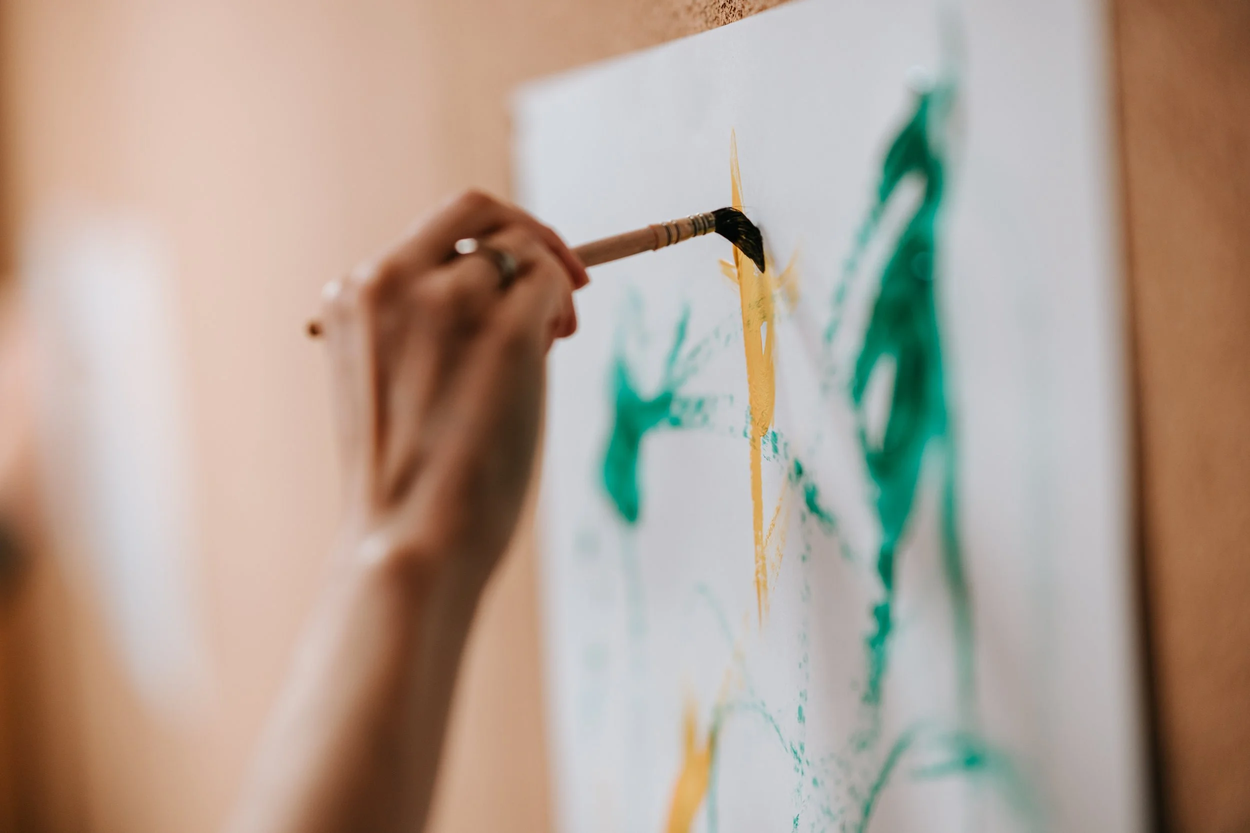 Hand and brush inside the shared material process.