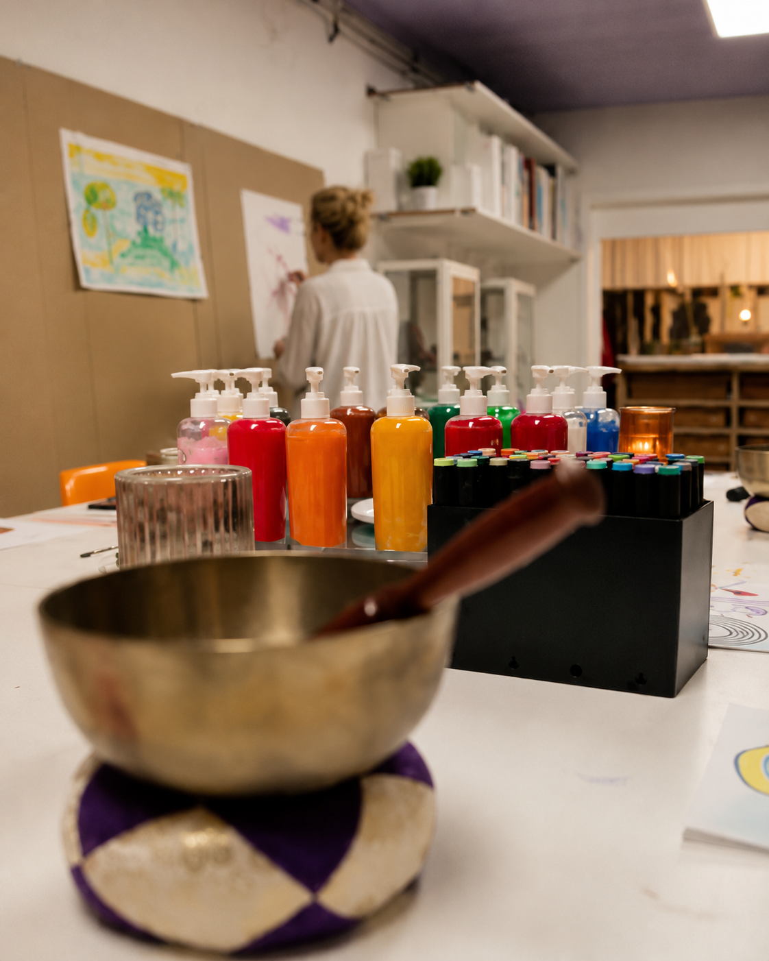 The ARTKOM atelier space set up with paints and materials, inviting participants in.