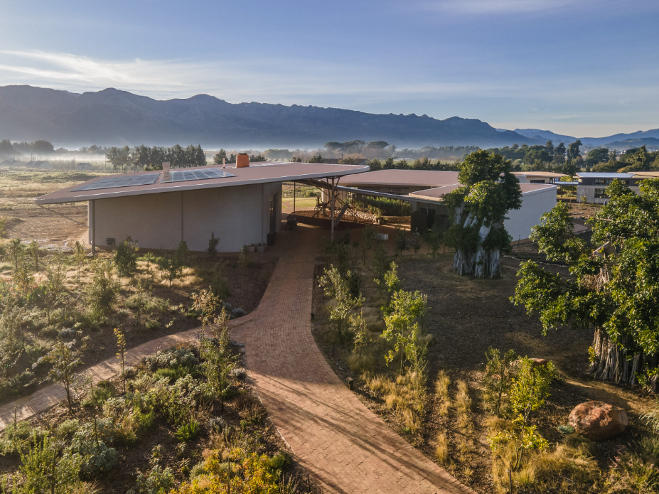 Green School South Africa campus buildings set against mountains and native landscape.